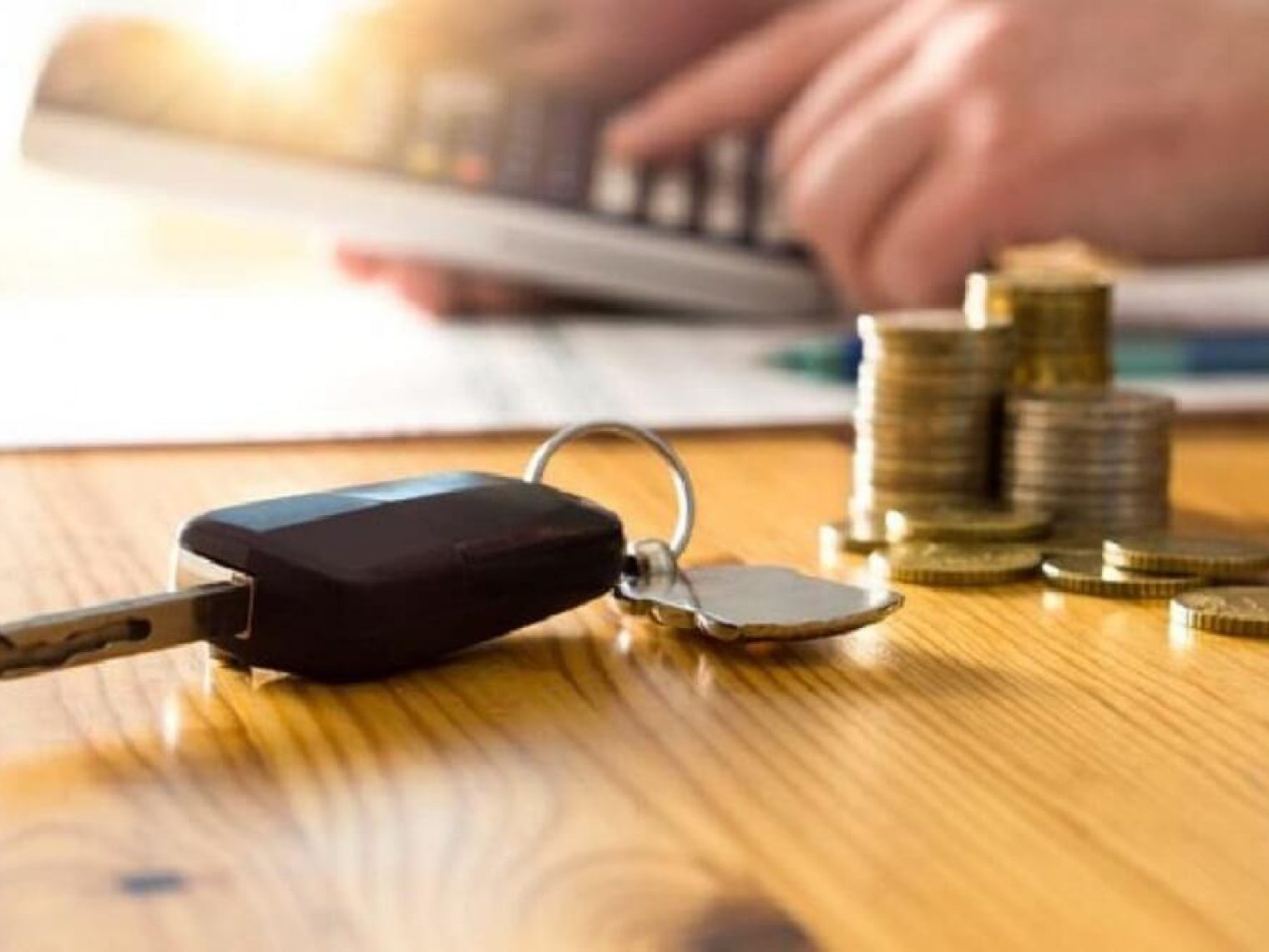 Car keys and money on a table.