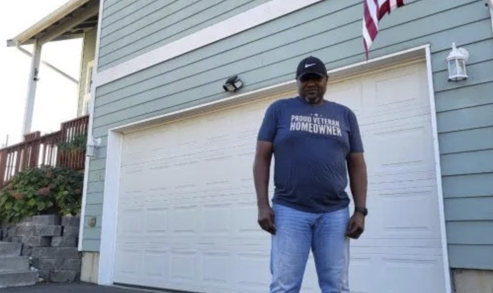 picture of Dwaun B. in front of a house