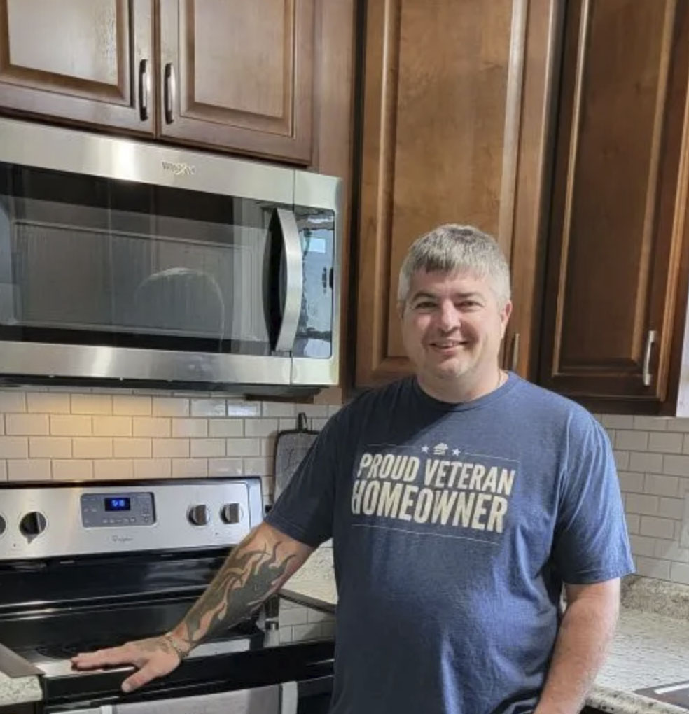 picture of Joshua D. in front of a house